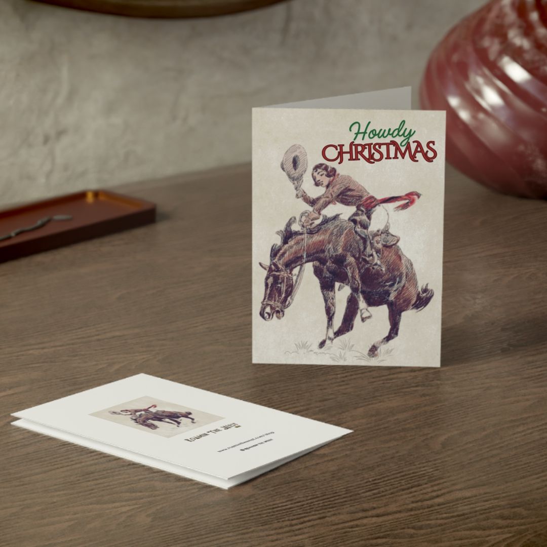 Christmas card with cowgirl riding a horse and 'Howdy Christmas' text on a wooden surface.