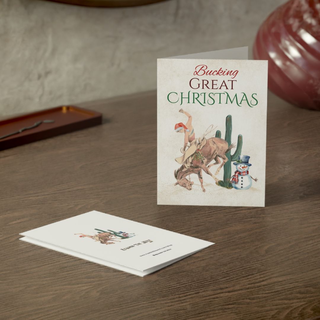Christmas card with cowboy and cactus design on a wooden surface
