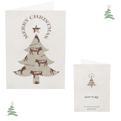 Christmas-themed card with tree and cow designs on a white background.