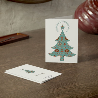Christmas card with a decorative tree design on a wooden surface